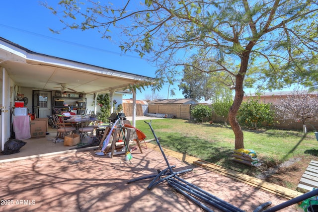 view of yard with ceiling fan, a fenced backyard, and a patio area