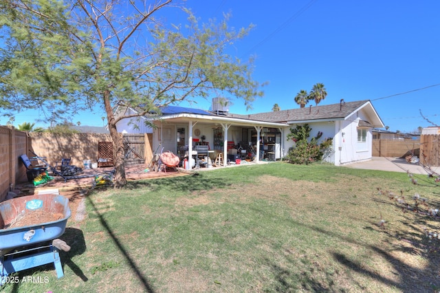 view of front of home featuring a fenced backyard, a patio, and a front lawn