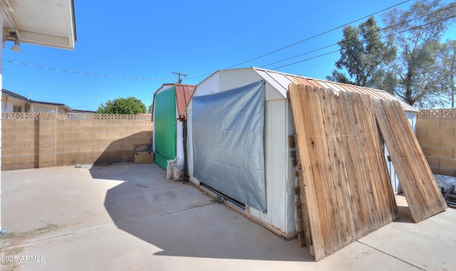 view of shed with a fenced backyard