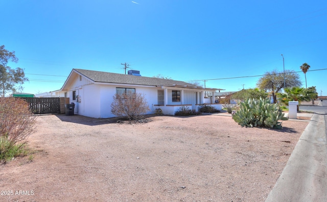 ranch-style house featuring central air condition unit and fence