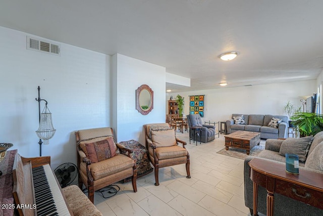 living area featuring visible vents and marble finish floor