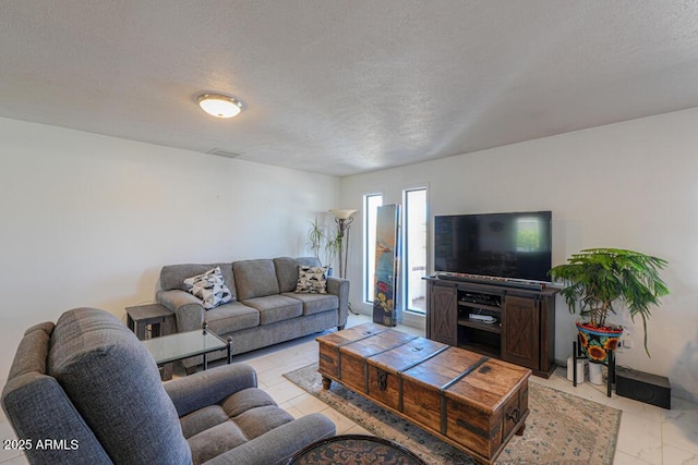 living room featuring visible vents and a textured ceiling