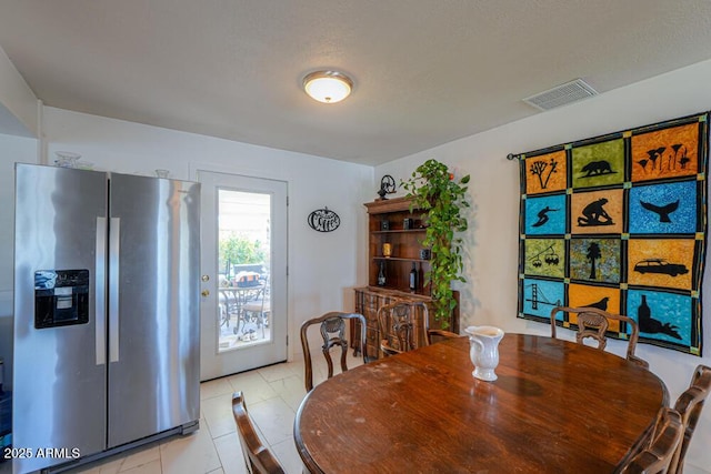 dining room with light tile patterned floors and visible vents