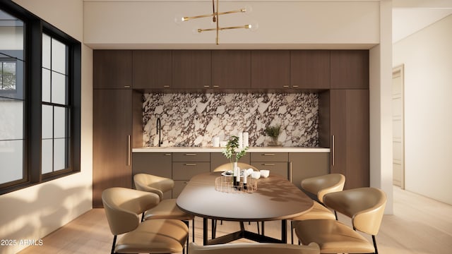 dining room with sink and light wood-type flooring