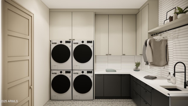 laundry room with cabinets, stacked washer and clothes dryer, sink, and washer and clothes dryer