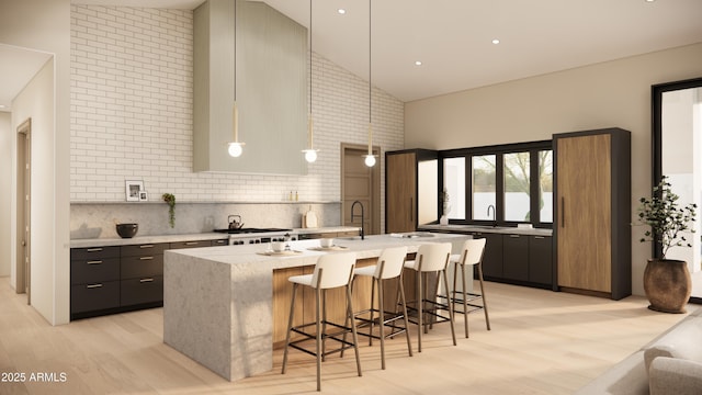 kitchen with a kitchen breakfast bar, high vaulted ceiling, hanging light fixtures, and a center island with sink