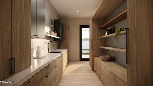 kitchen with sink, backsplash, and light hardwood / wood-style floors