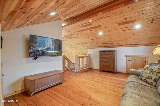 living room featuring light hardwood / wood-style floors, high vaulted ceiling, wooden ceiling, and wood walls