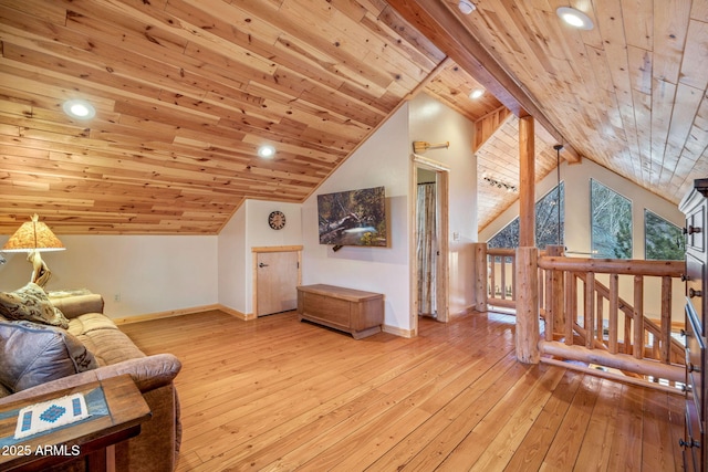 additional living space with light wood-type flooring, vaulted ceiling with beams, and wood ceiling