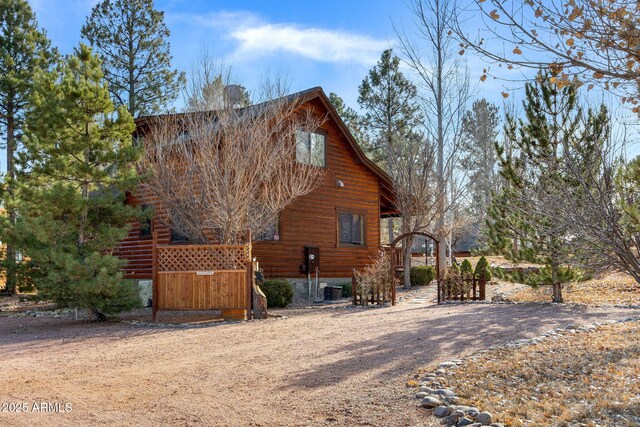 rear view of property with central AC