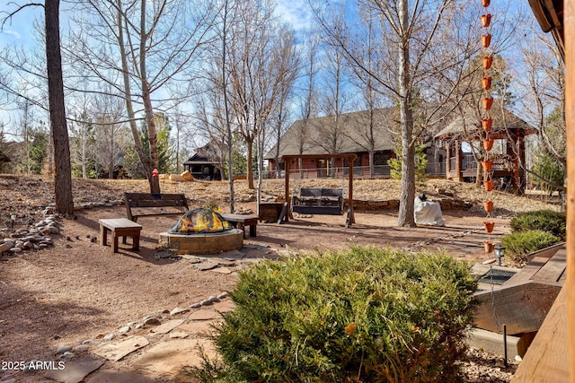 view of yard with an outdoor fire pit