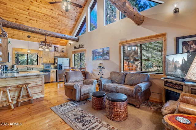 living room with light wood-type flooring, ceiling fan, beam ceiling, high vaulted ceiling, and plenty of natural light