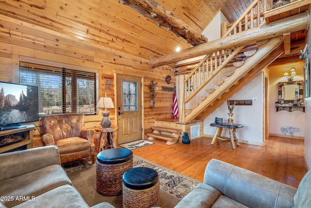 living room with wood-type flooring, high vaulted ceiling, wooden ceiling, beamed ceiling, and wood walls