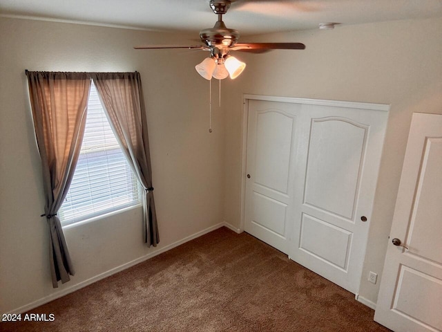 unfurnished bedroom with carpet floors, ceiling fan, and a closet