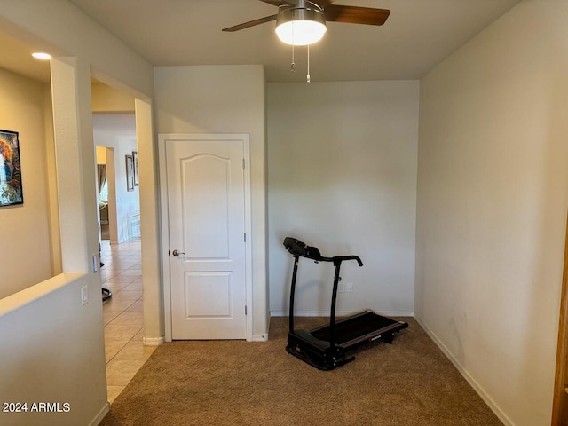 workout area with ceiling fan and light colored carpet