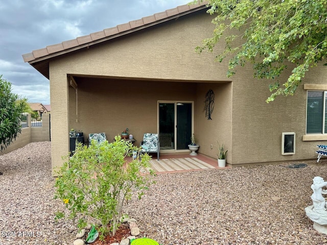 rear view of property featuring a deck