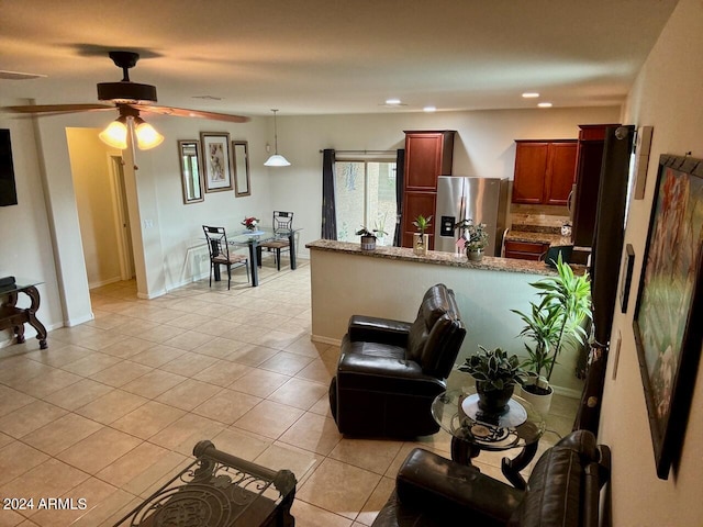 living room with ceiling fan and light tile patterned floors