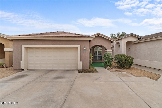 ranch-style home with a tiled roof, stucco siding, an attached garage, and driveway