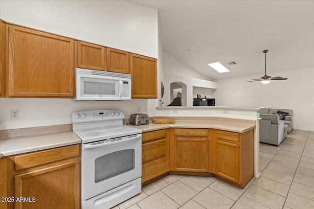 kitchen featuring open floor plan, white appliances, a peninsula, light countertops, and light tile patterned floors