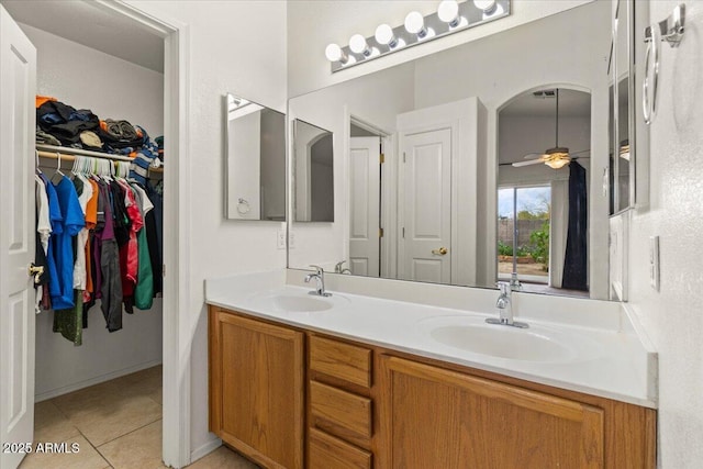 bathroom with tile patterned flooring, double vanity, a ceiling fan, and a sink