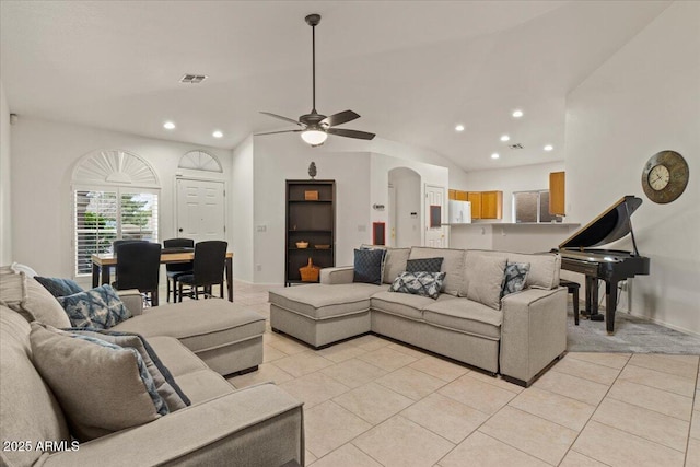 living area with visible vents, recessed lighting, arched walkways, light tile patterned floors, and vaulted ceiling