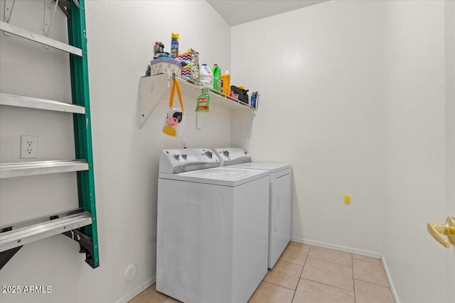 laundry area with laundry area, light tile patterned floors, baseboards, and independent washer and dryer