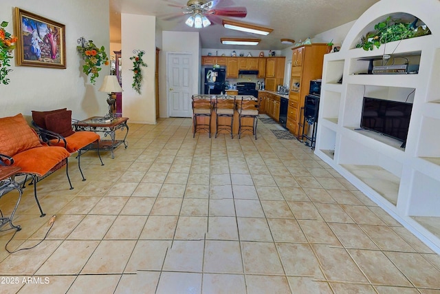 living room featuring ceiling fan, light tile patterned flooring, and built in features