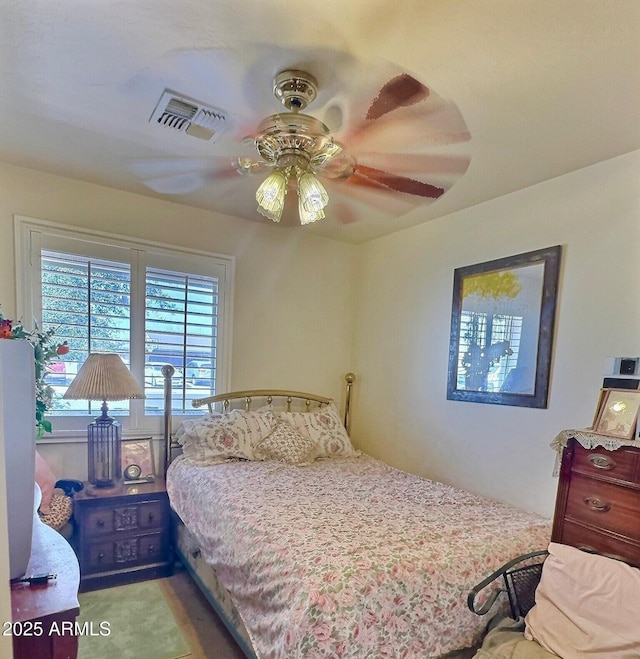 bedroom with a ceiling fan and visible vents