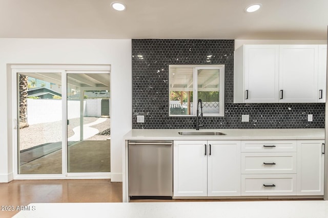 kitchen with white cabinetry, sink, tasteful backsplash, and stainless steel dishwasher