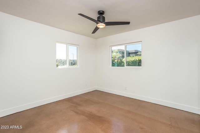 empty room with a wealth of natural light and ceiling fan