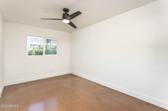 spare room with concrete flooring and ceiling fan