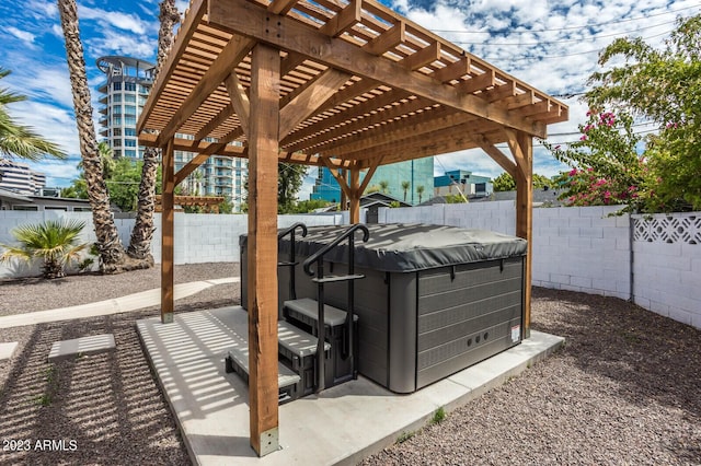 view of patio / terrace featuring a pergola and a hot tub