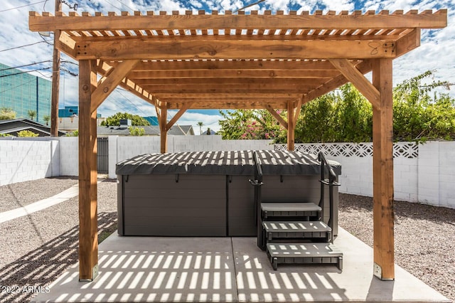 view of patio featuring a hot tub and a pergola