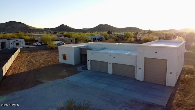 2534 W Fernwood Dr, Phoenix, AZ 85086 - exterior space featuring stucco siding, a garage, a mountain view, and driveway