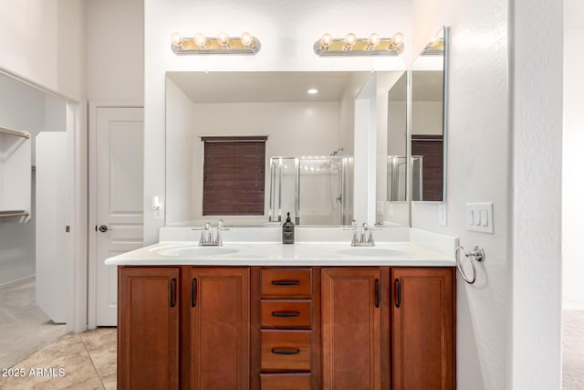 18072 W Paradise Ln, Surprise, AZ 85388 - bathroom featuring double vanity, a sink, a stall shower, and tile patterned floors