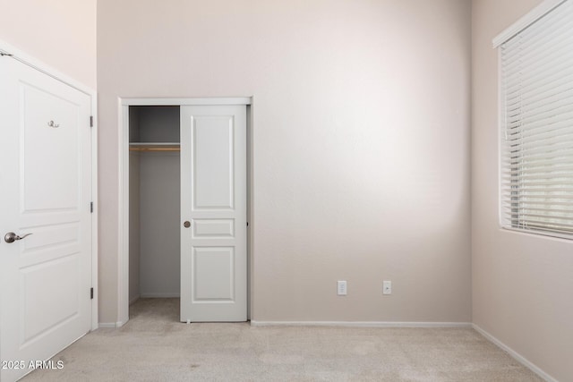 18072 W Paradise Ln, Surprise, AZ 85388 - unfurnished bedroom with baseboards, light colored carpet, and a closet