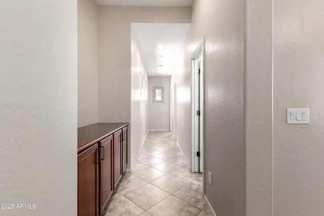 18072 W Paradise Ln, Surprise, AZ 85388 - hallway featuring light tile patterned floors, baseboards, and a textured wall