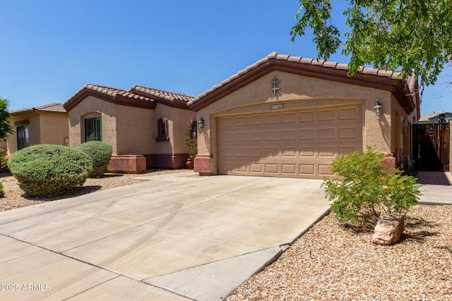 18072 W Paradise Ln, Surprise, AZ 85388 - view of front of home with a tiled roof, a garage, stucco siding, and driveway