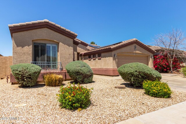 18072 W Paradise Ln, Surprise, AZ 85388 - mediterranean / spanish house featuring a tiled roof, a garage, and stucco siding