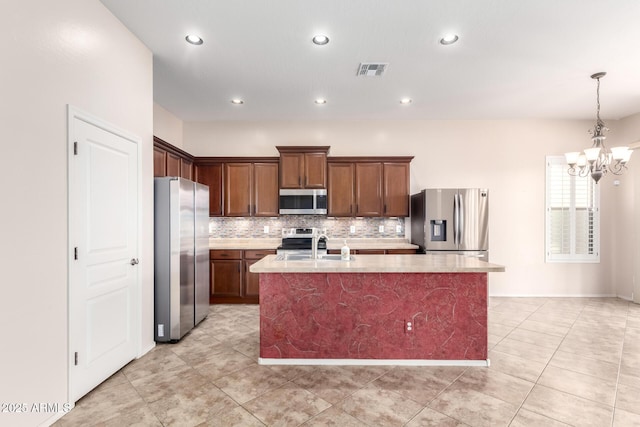 18072 W Paradise Ln, Surprise, AZ 85388 - kitchen with decorative backsplash, visible vents, appliances with stainless steel finishes, light countertops, and a chandelier