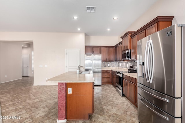 18072 W Paradise Ln, Surprise, AZ 85388 - kitchen featuring visible vents, decorative backsplash, a center island with sink, light countertops, and appliances with stainless steel finishes
