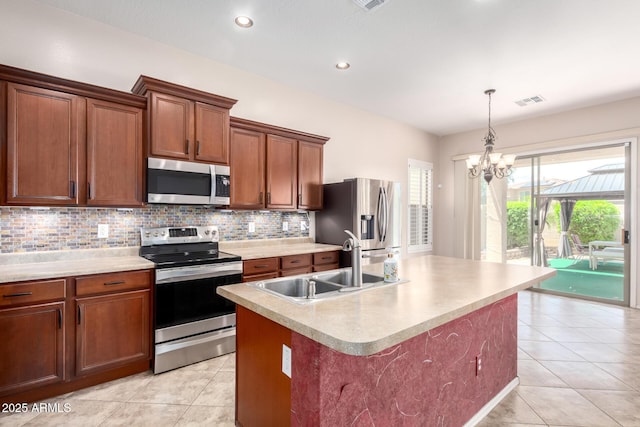 18072 W Paradise Ln, Surprise, AZ 85388 - kitchen with an inviting chandelier, tasteful backsplash, a sink, appliances with stainless steel finishes, and light tile patterned floors