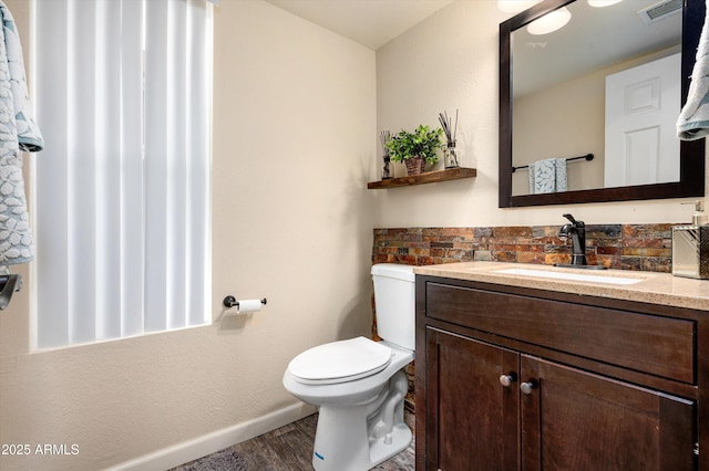 bathroom featuring hardwood / wood-style floors, vanity, and toilet