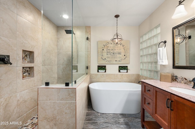 bathroom featuring vanity and separate shower and tub