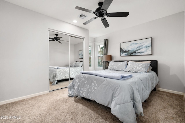 carpeted bedroom with a closet and ceiling fan