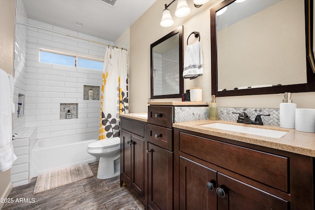 full bathroom featuring backsplash, vanity, shower / bath combo with shower curtain, hardwood / wood-style floors, and toilet