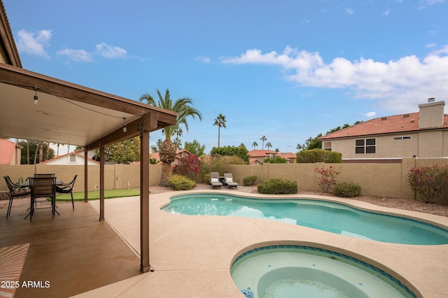 view of swimming pool with an in ground hot tub and a patio