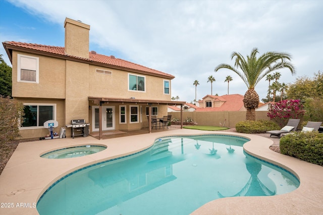 view of swimming pool featuring a grill, an in ground hot tub, and a patio area