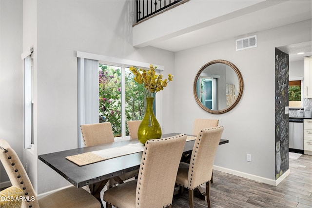 dining space with hardwood / wood-style flooring