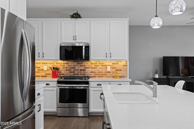 14573 W Reade Ave, Litchfield Park, AZ 85340 - kitchen with appliances with stainless steel finishes, light countertops, white cabinetry, dark wood-style flooring, and tasteful backsplash